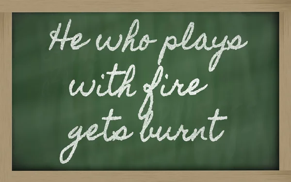 Ausdruck - wer mit dem Feuer spielt, wird verbrannt - geschrieben auf ein s — Stockfoto