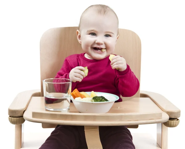 stock image Young child eating in high chair