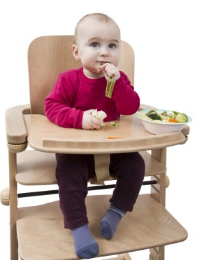 Young child eating in high chair clipart