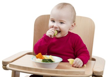 Young child eating in high chair clipart