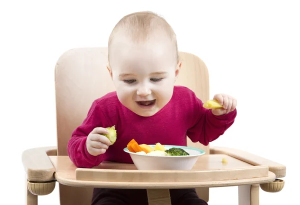 Kleinkind isst im Hochstuhl — Stockfoto