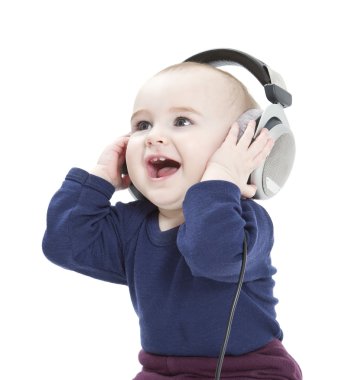 Young child with ear-phones listening to music clipart