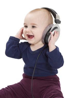 Young child with ear-phones listening to music clipart