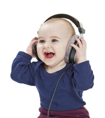 Young child with ear-phones listening to music clipart