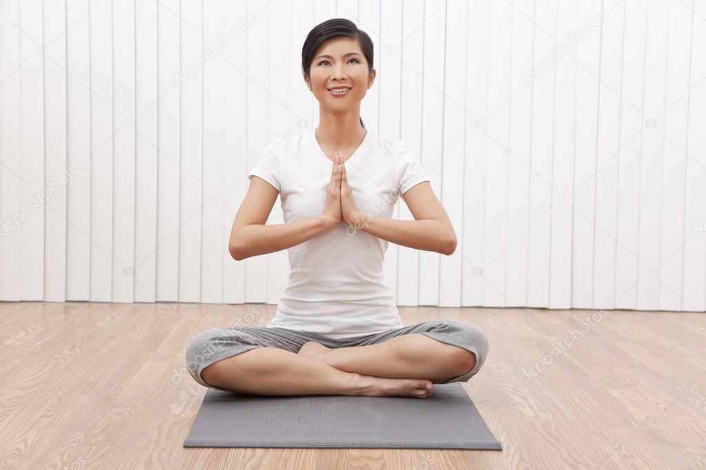 Yoga exercise sitting cross-legged rear view Stock Photo - Alamy