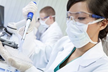 Chinese Female Woman Scientist Using Pipette In Laboratory clipart