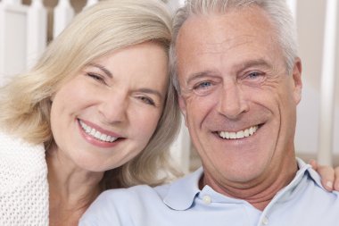 Happy Senior Man & Woman Couple Smiling at Home clipart