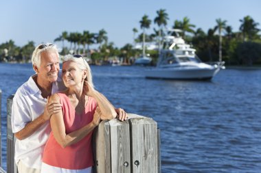 Happy Senior Couple By River or Sea with Boat clipart