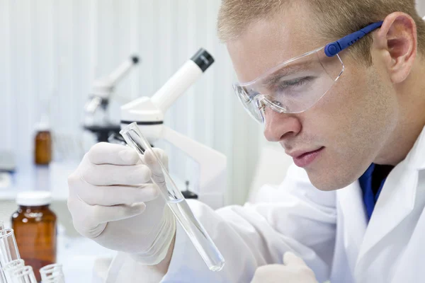 Scienziato o medico maschio con provetta in laboratorio — Foto Stock