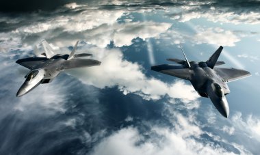 Two F-22 Raptors in high attitude above the clouds