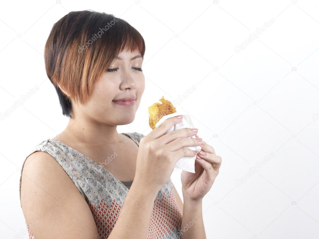 Chinese Asian Lady enjoying her snack