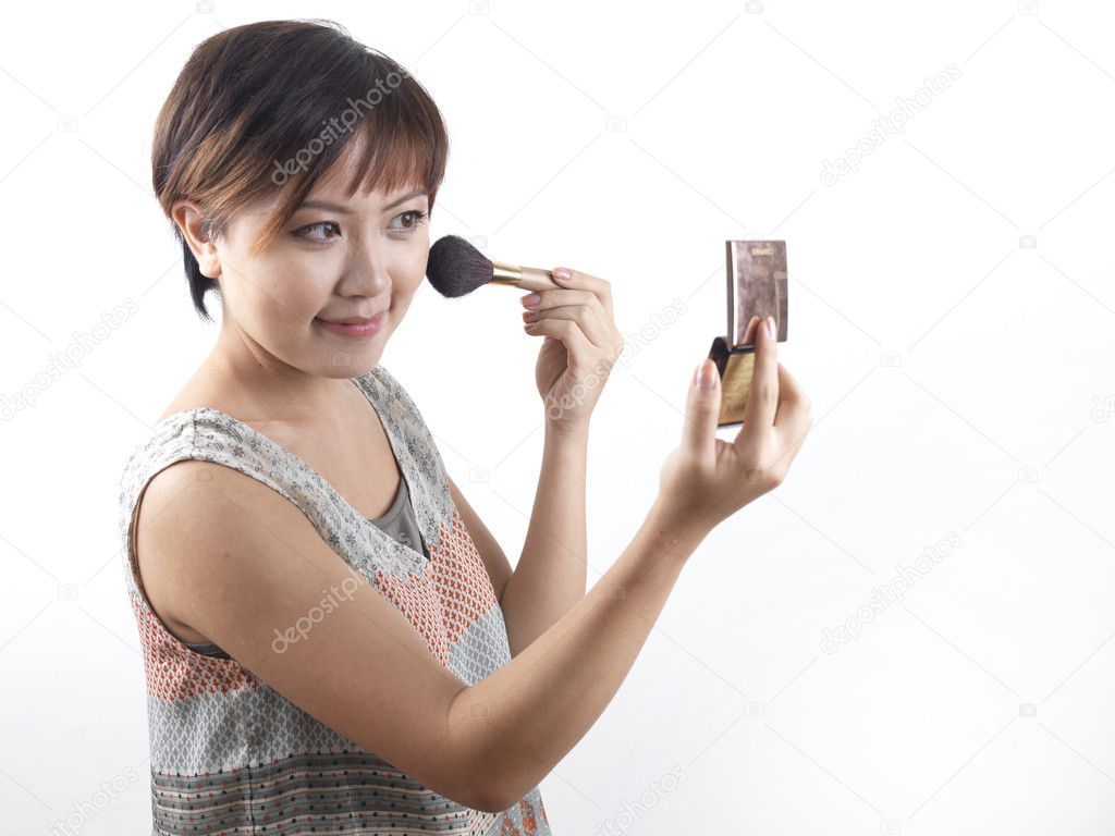 Asian Chinese Woman putting on make up