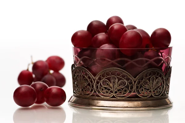 stock image Grapes in a colored transparent bowl