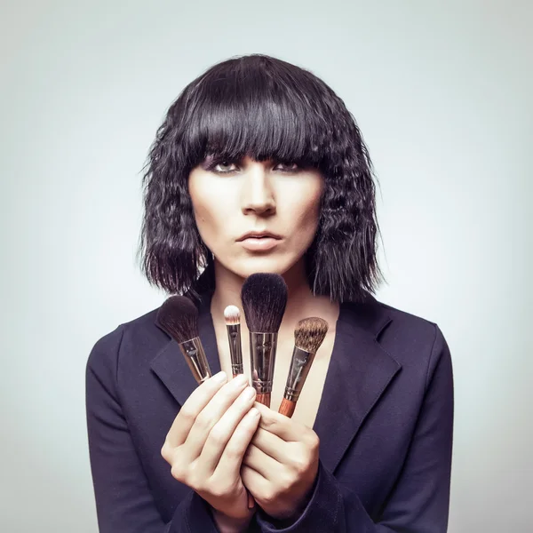 Portrait of beautiful woman with makeup brushes — Stock Photo, Image