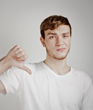 Young man shows thumb down clipart