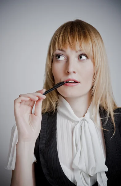 Beautiful woman standing with a pen — Stock Photo, Image