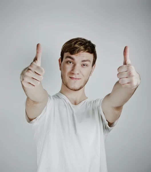 Portrait of a handsome young man showing thumbs up — Stock Photo, Image
