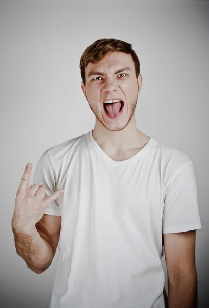 Close up portrait of man showing "rock on" gesture — Stock Photo, Image