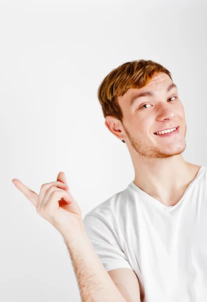 Portrait of young man pointing with finger — Stock Photo, Image