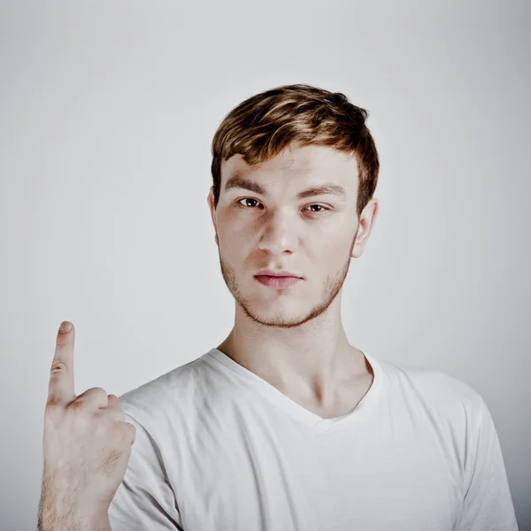 Young man holding up one finger — Stock Photo, Image