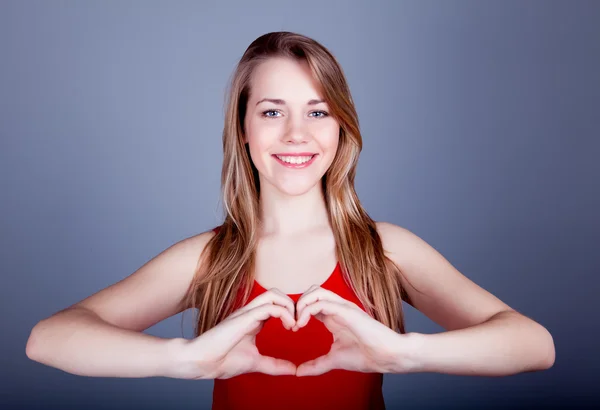 Portrait of a pretty young woman a red heart — Stock Photo, Image