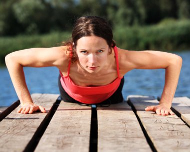 Woman doing push-ups clipart