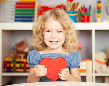 Happy child with paper heart clipart