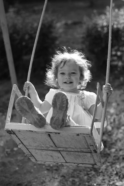 Playing on the swings after summer rain — Stock Photo, Image