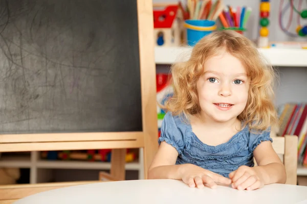 Smiling schoolchild in a class — Stock Photo, Image