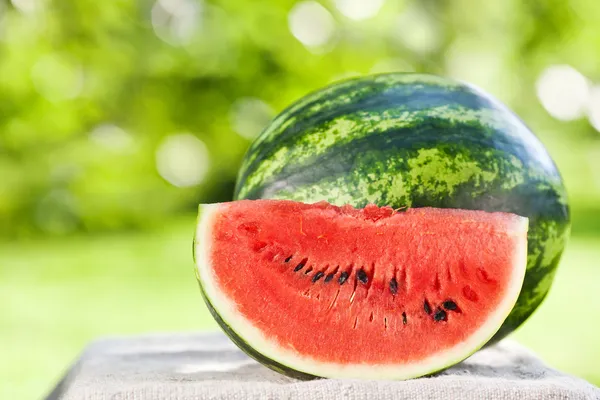 Fresh watermelon against natural background — Stock Photo, Image