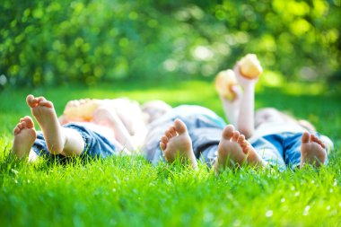 Children feet in green grass clipart