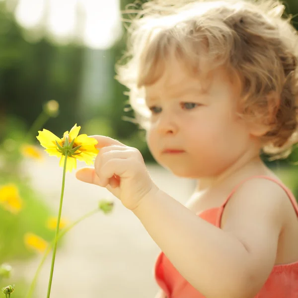 Dziecko dotykając wiosna kwiatów — Zdjęcie stockowe