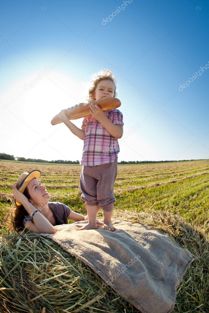 Happy woman and child in wheat field