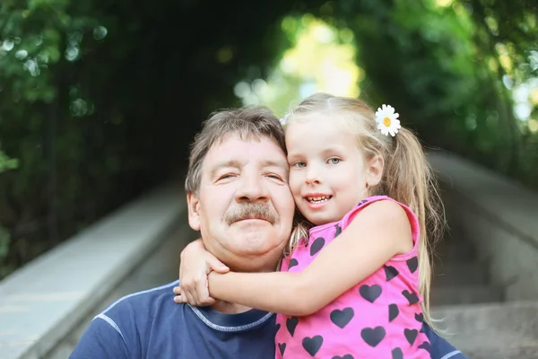 stock image Portrait of grandfather with granddaughter outdoor