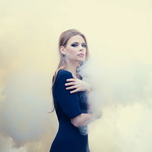 Sensual beautiful girl in white smoke on nature — Stock Photo, Image