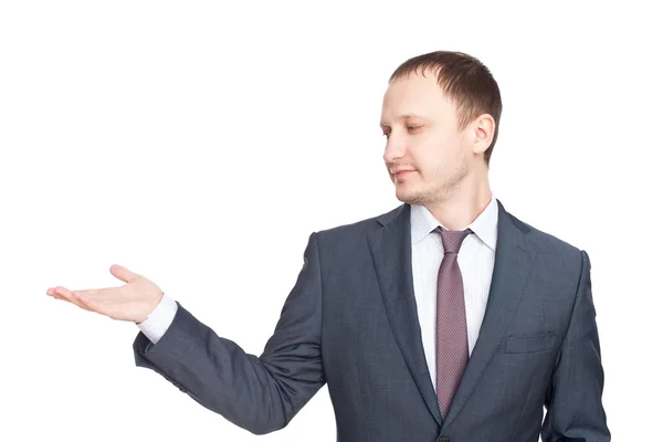 Young businessman in a suit presenting something isolated on whi Royalty Free Stock Images