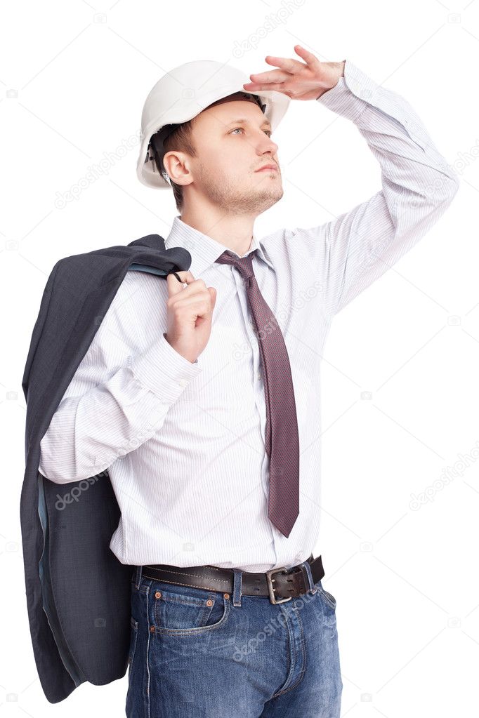 Young engineer looking far away holds jacket behind shoulder iso