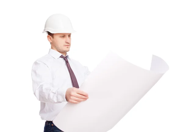 Young engineer looking at blueprint isolated on white background — Stock Photo, Image