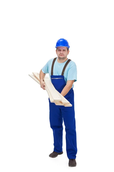 Construction worker carrying wooden plancks — Stock Photo, Image