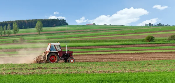 Small tractor harrow on the spring field — Stock Photo, Image