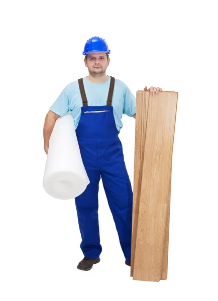 Worker ready to lay laminate flooring — Stock Photo, Image