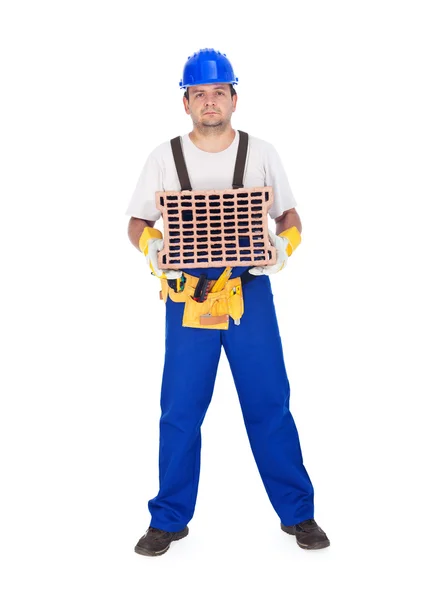 Handyman or worker holding brick — Stock Photo, Image