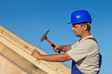 Carpenter working on the roof clipart