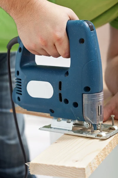 Carpenter or joiner working with electric saw — Stock Photo, Image