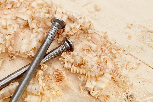 Wood surface, shavings and nails — Stock Photo, Image