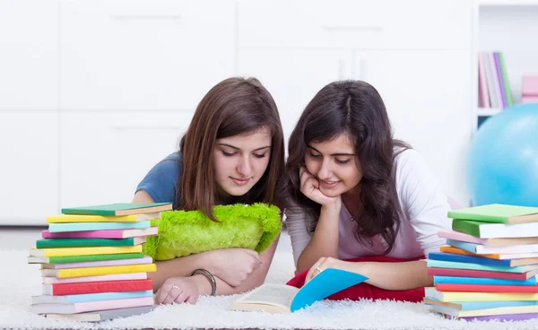 Young girl helps her friend learning — Stock Photo, Image