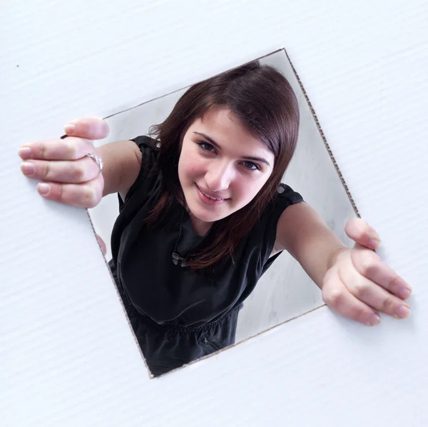 stock image Teenager crawling and peeking out of a hole