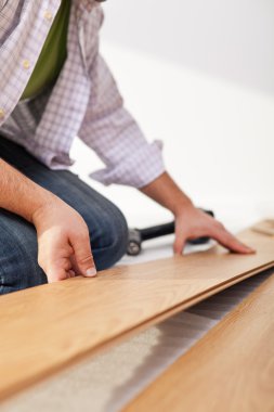 Laying laminate flooring - closeup clipart