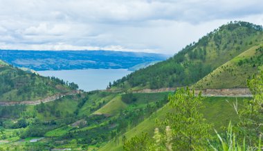 View of mountains in Sumatra and Lake Toba clipart