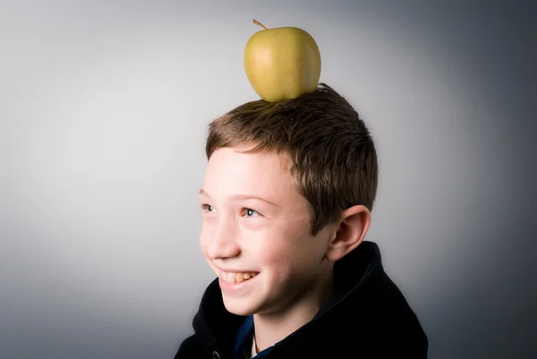 Boy with a green apple on his head — Stock Photo, Image